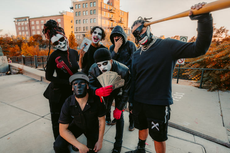 rappers dressed as clowns pose in a parking lot