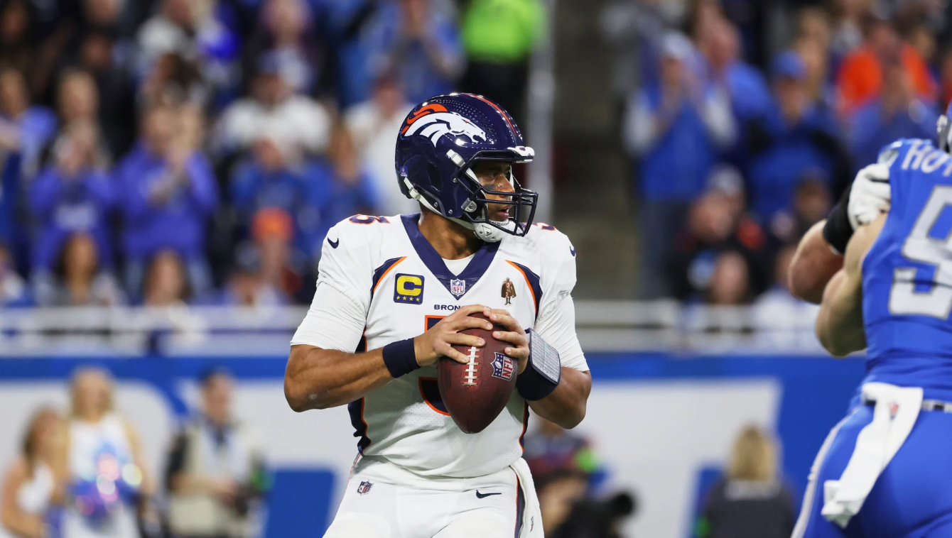 Denver Broncos quarterback Russell Wilson dropping back for a pass against the Detroit Lions.