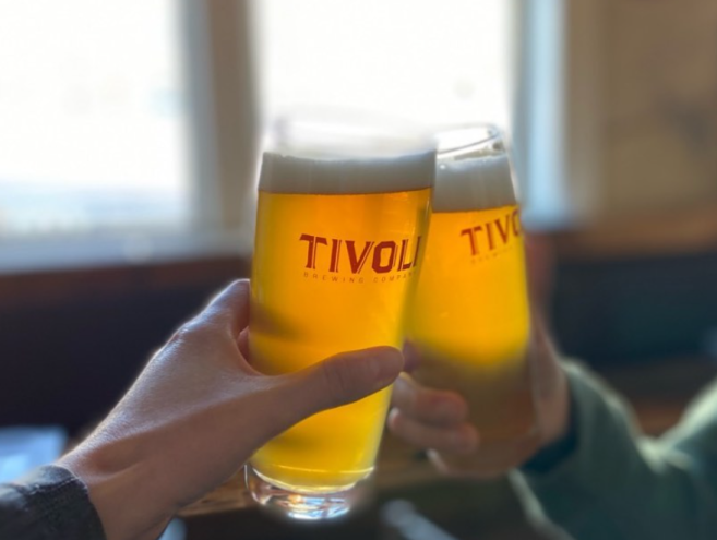 hands holding pints of beer