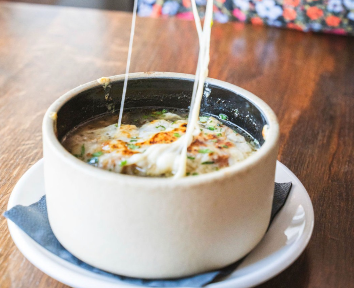 a bowl of french onion soup topped with cheese