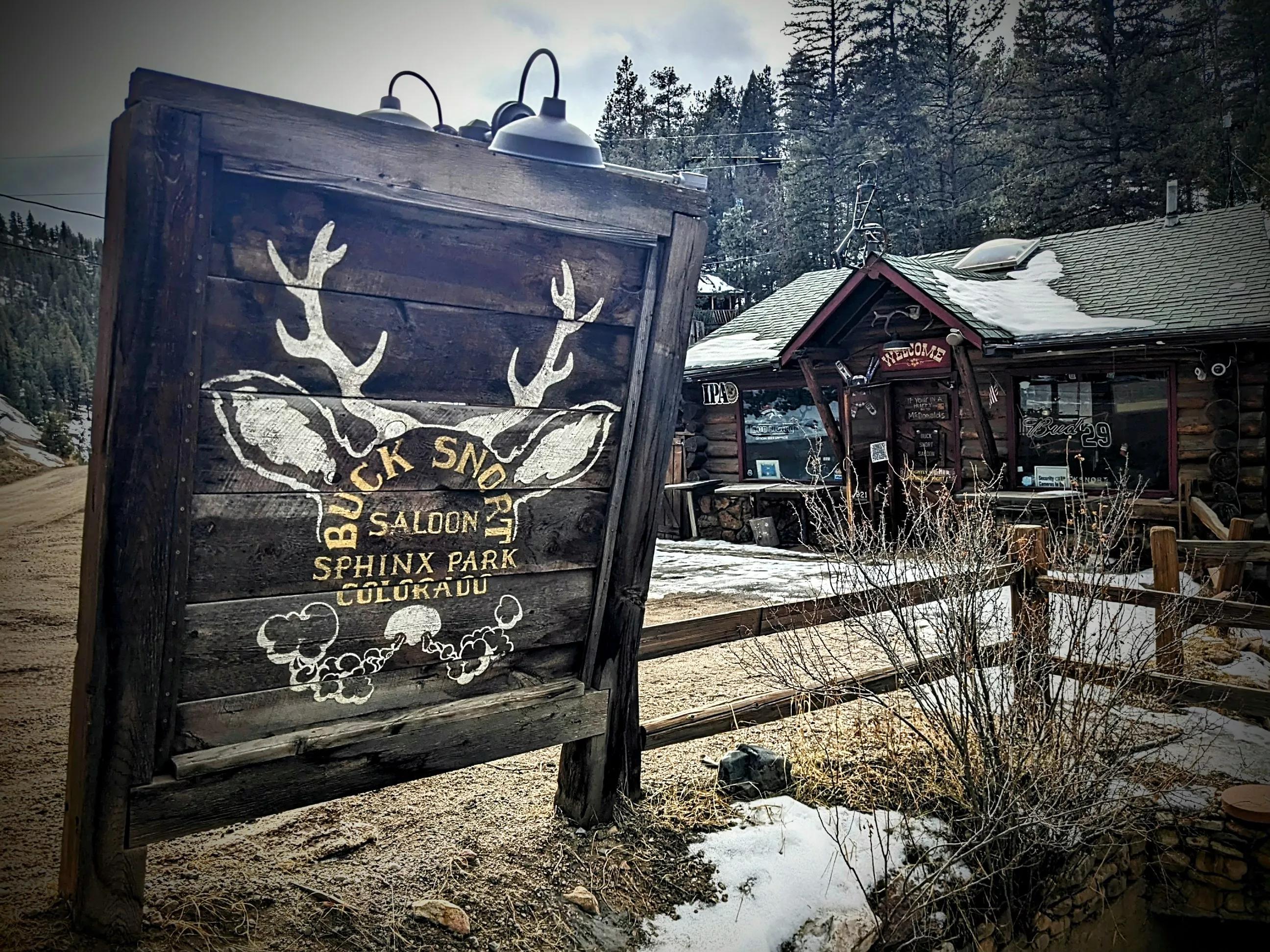 rustic sign outside of a wooden building