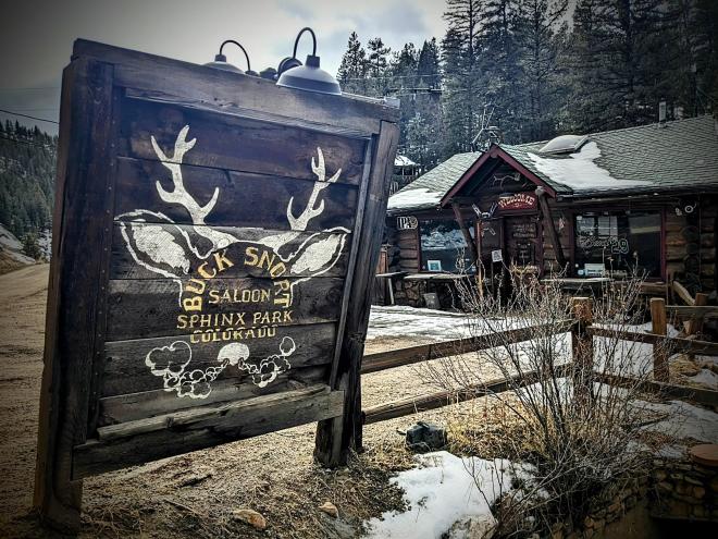 rustic sign outside of a wooden building