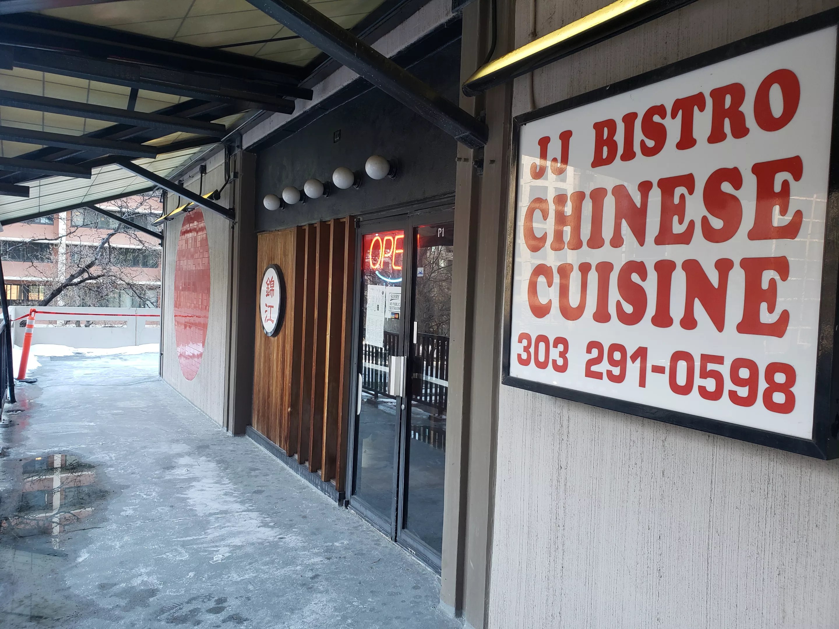 a red and white sign outside a storefront
