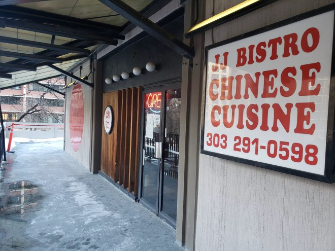 a red and white sign outside a storefront