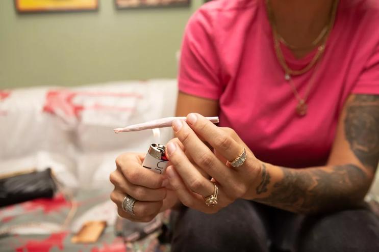 Woman lights a joint