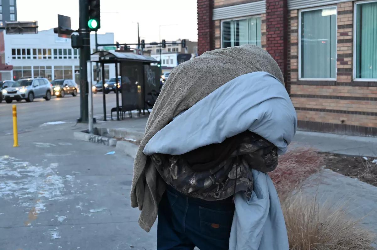 Homeless resident Josh Rush looks for a place to get warm.