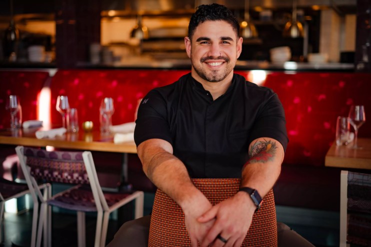 a man in a black chef's coat
