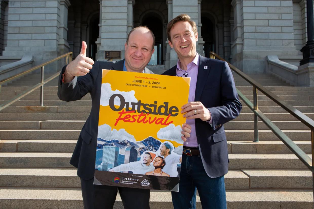 two men in suits with poster