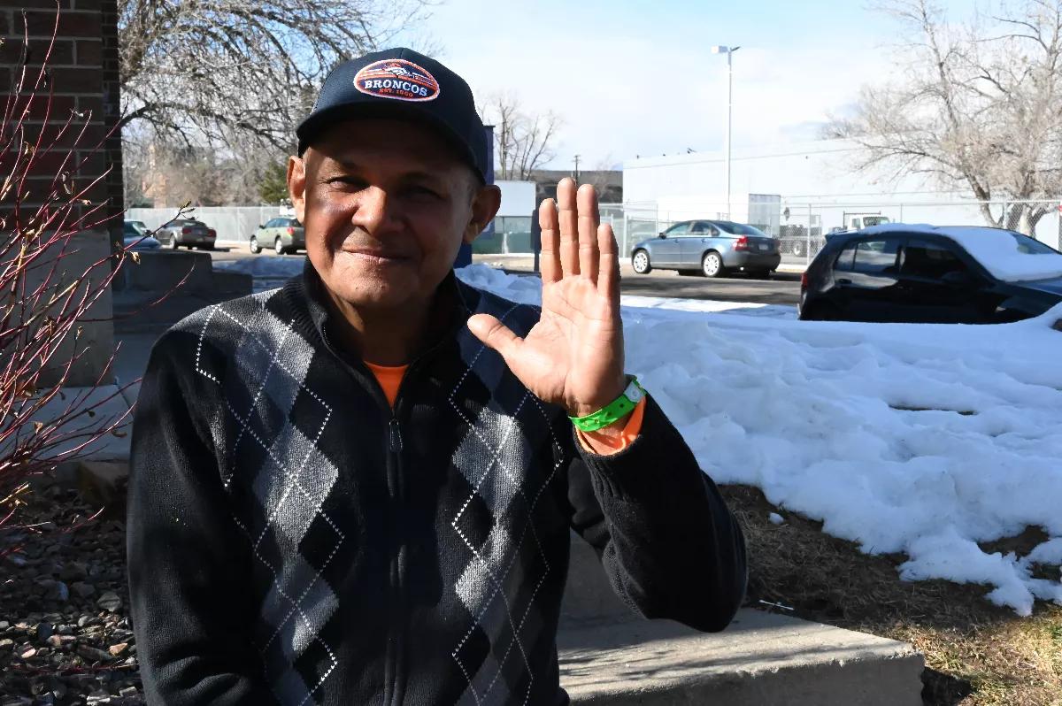 A migrant waves hi.