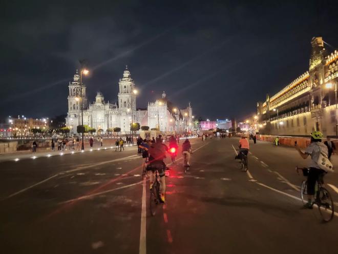 A man rides a bike through Mexico City