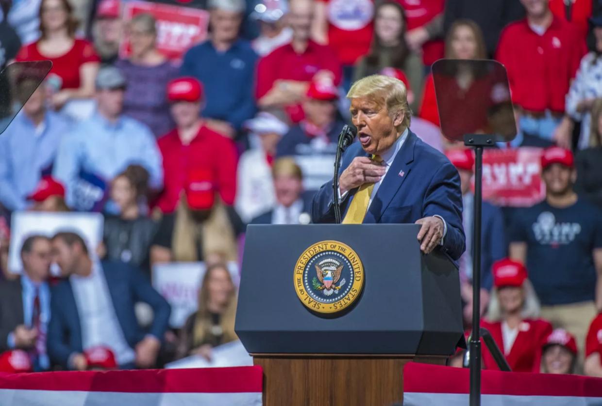 Donald Trump before a crowd.