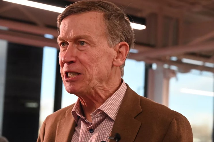 John Hickenlooper talks to reporters.