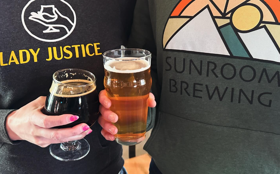 hands holding two glasses of beer