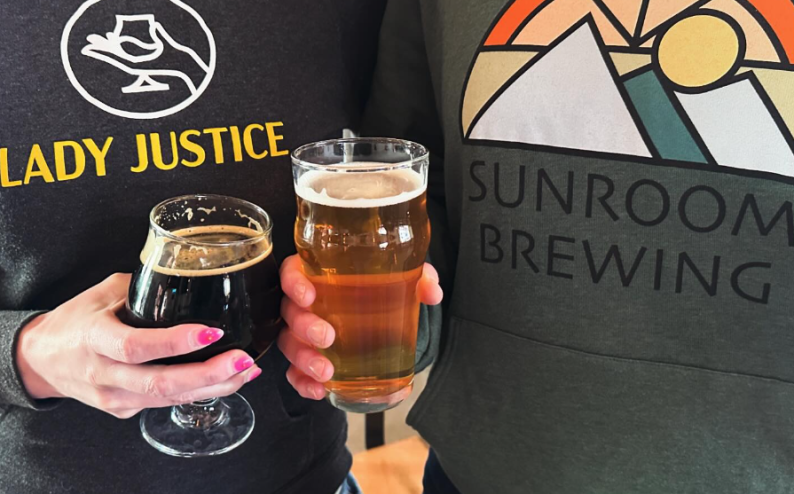 hands holding two glasses of beer