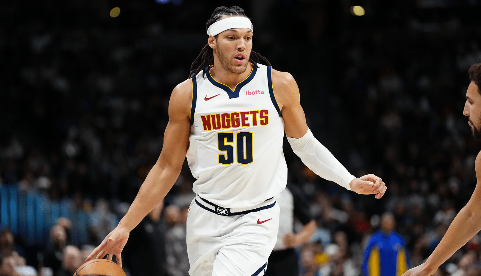 Denver Nuggets player Aaron Gordon dribbling a basketball.