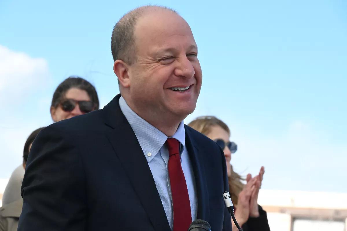 The governor smiles outside.