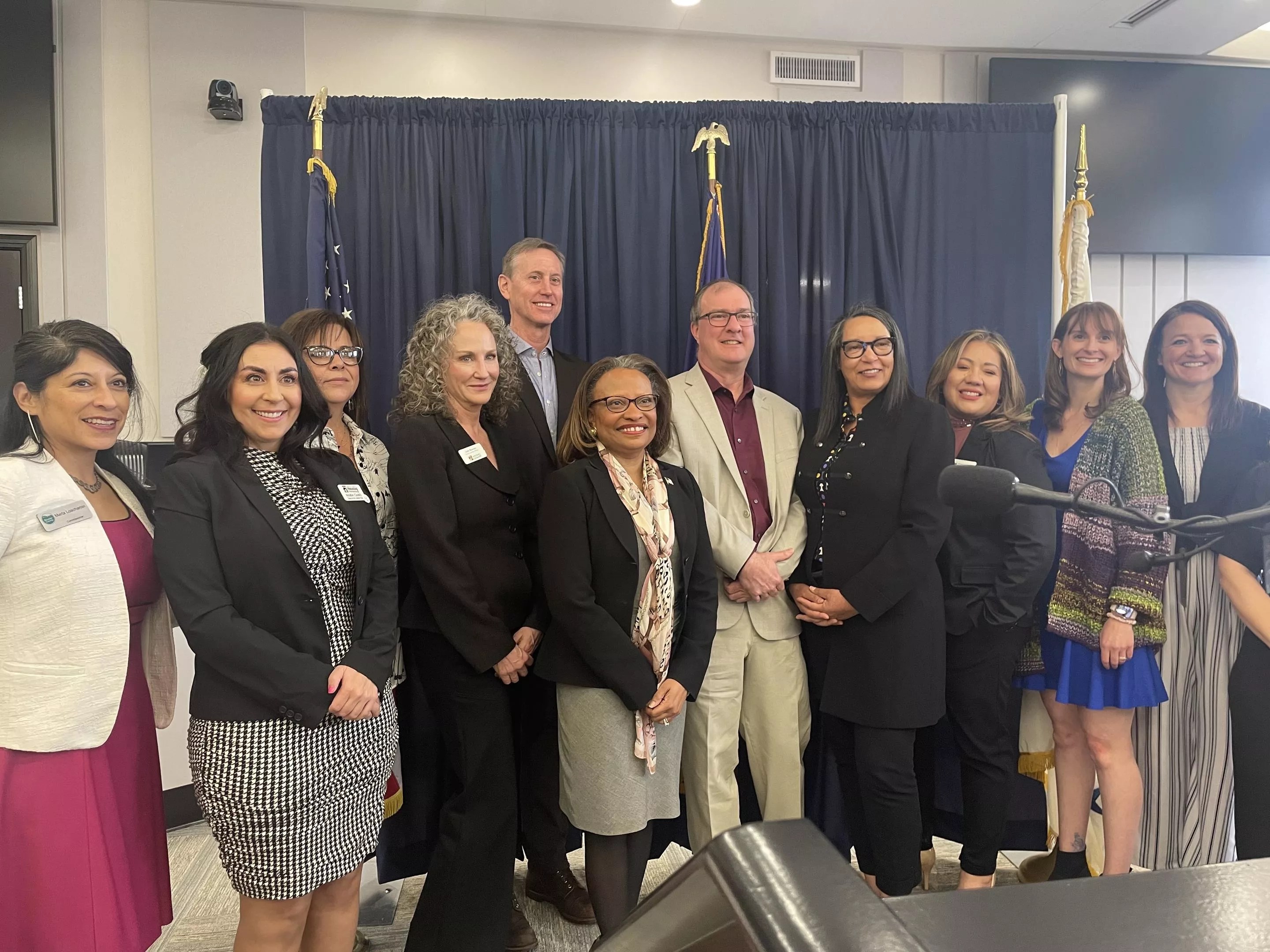 Government representatives from Boulder and Washington D.C. take a photo during a press conference