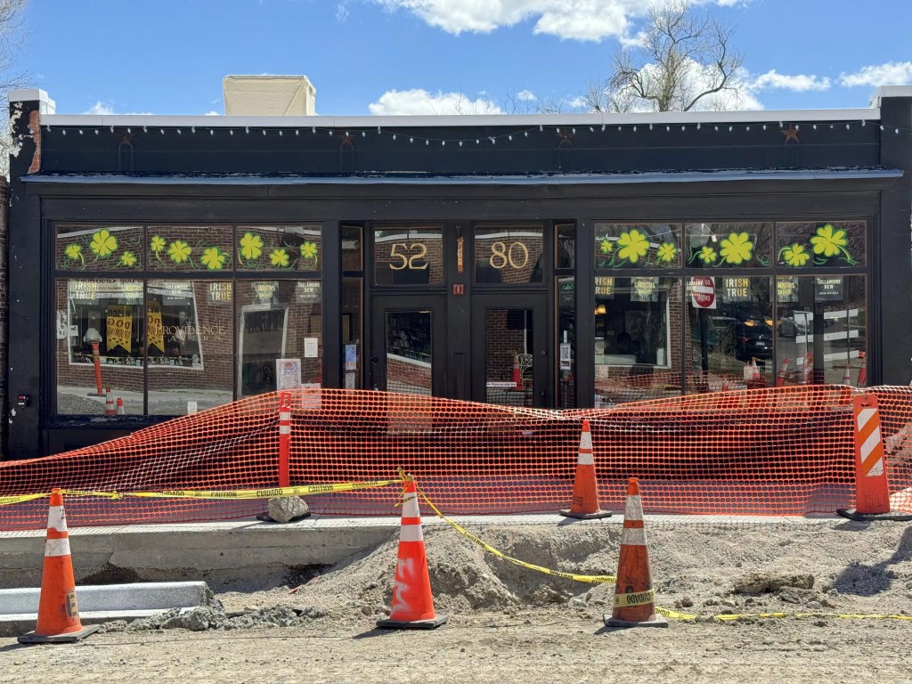 front of a building with construction in progress on the street