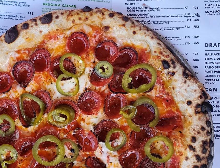 pizza with pepperoni on placemat