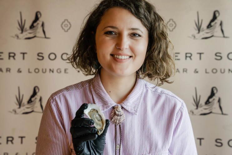 woman holding an oyster