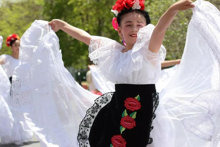 woman in Mexican dress dancing.