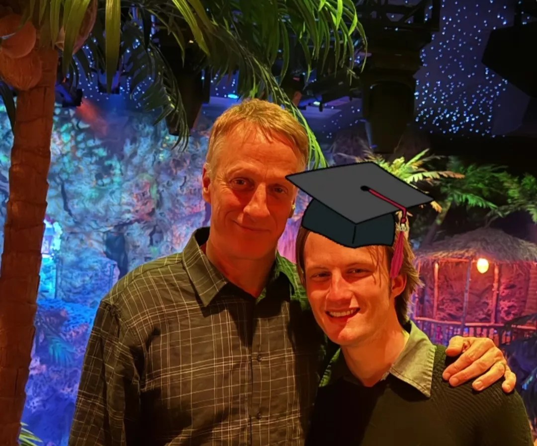 graduation cap graphic on a man posing with his father