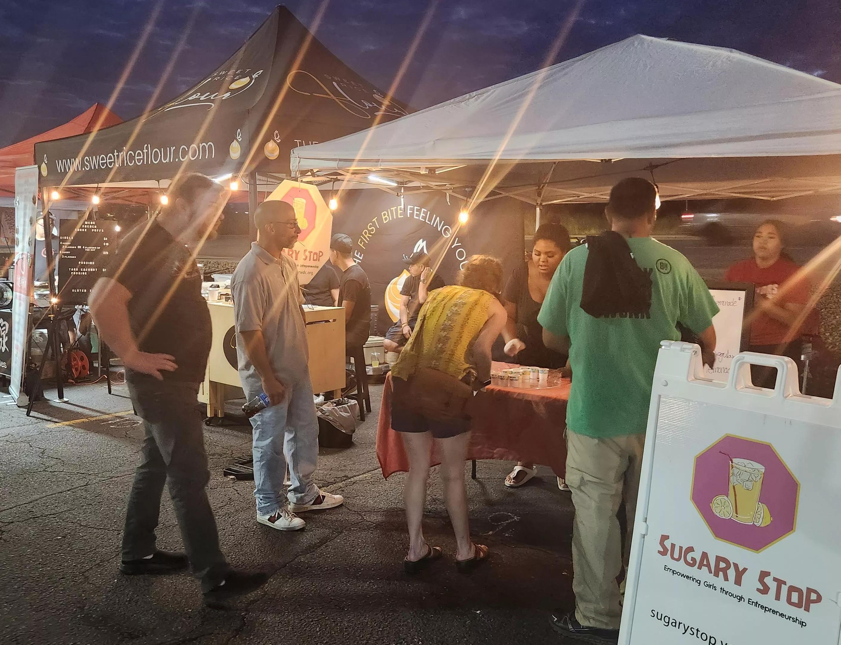 Children selling lemonade at night market