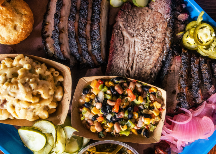 a platter of barbecue meats and sides