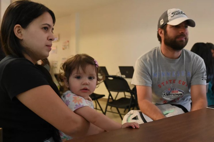 A couple holds a baby.