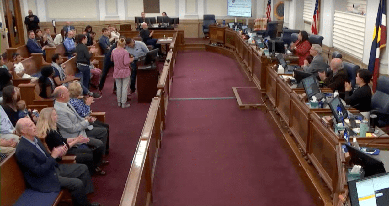 Crowds surround Denver City Council during a meeting