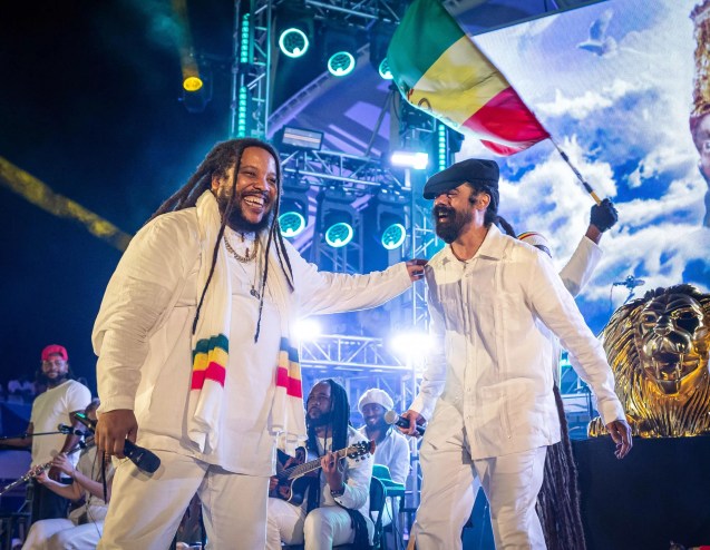 Two men on stage in white outfits