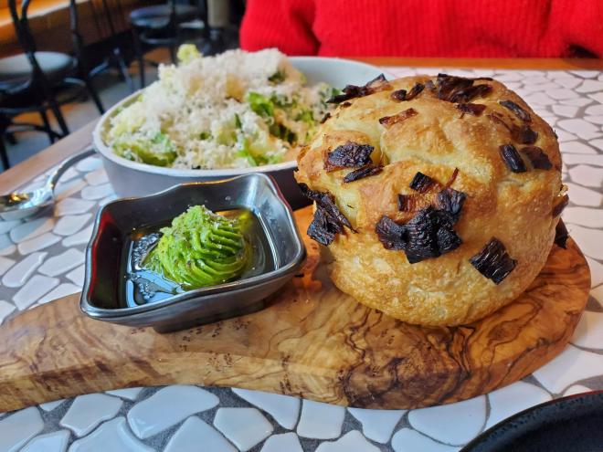 round loaf of Focaccia and a Caesar salad