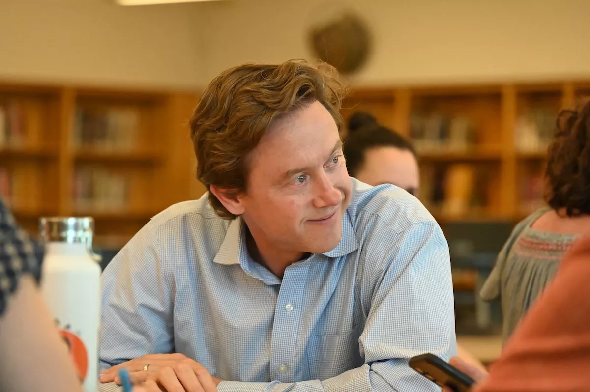 A man smiles.