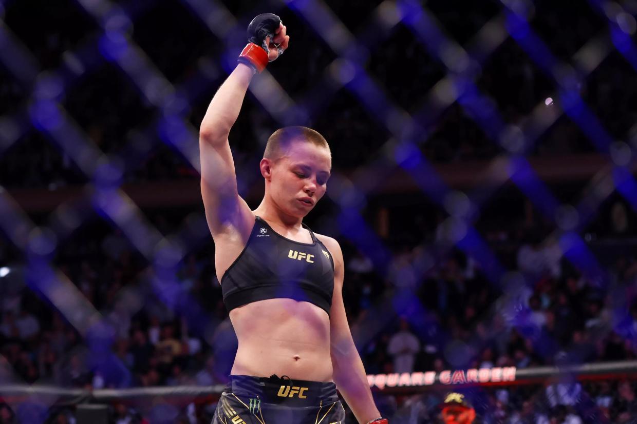 MMA fighter with fist up in cage