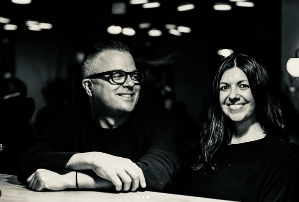 black and white photo of a man in glasses and a woman
