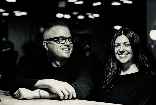 black and white photo of a man in glasses and a woman