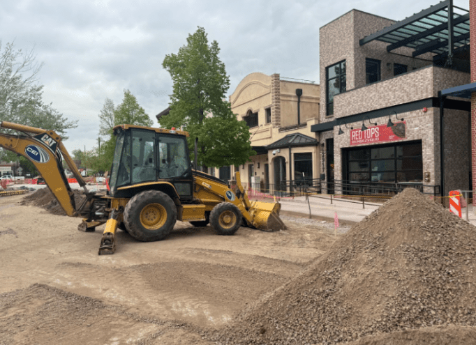a bulldozer in front of a storefront