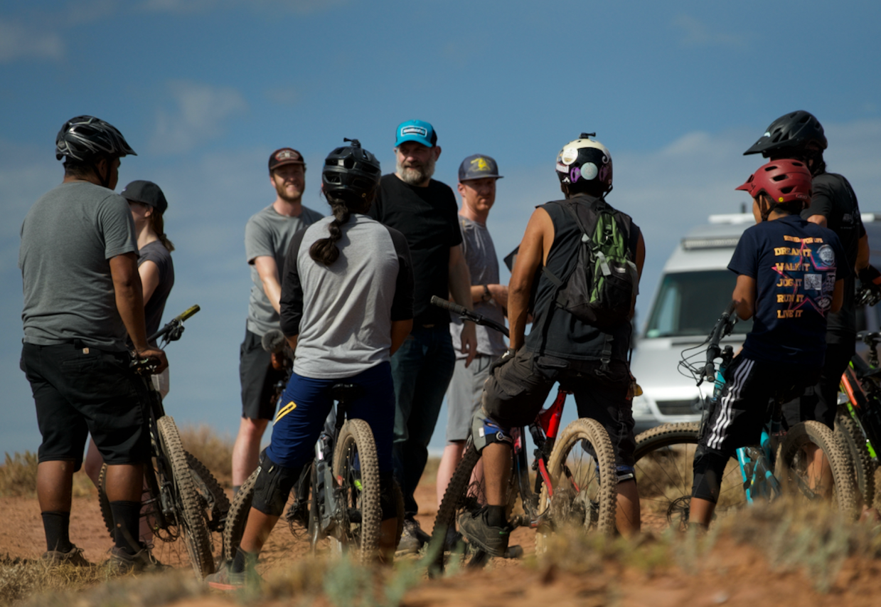 People on mountain bikes talking to film director T.C. Johnstone in Navajo Nation.