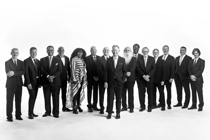 lyle lovett and his large band pose for a photoshoot