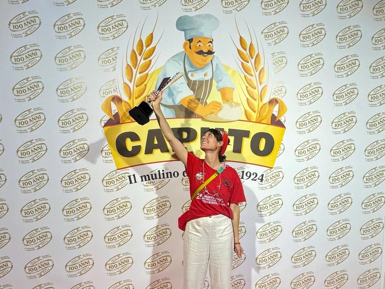 woman in a red shirt holding a trophy in the air