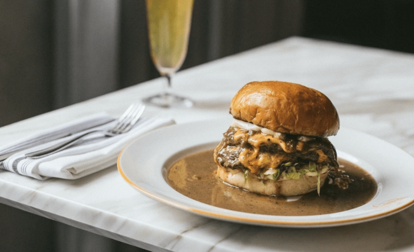 a cheeseburger on a white plate