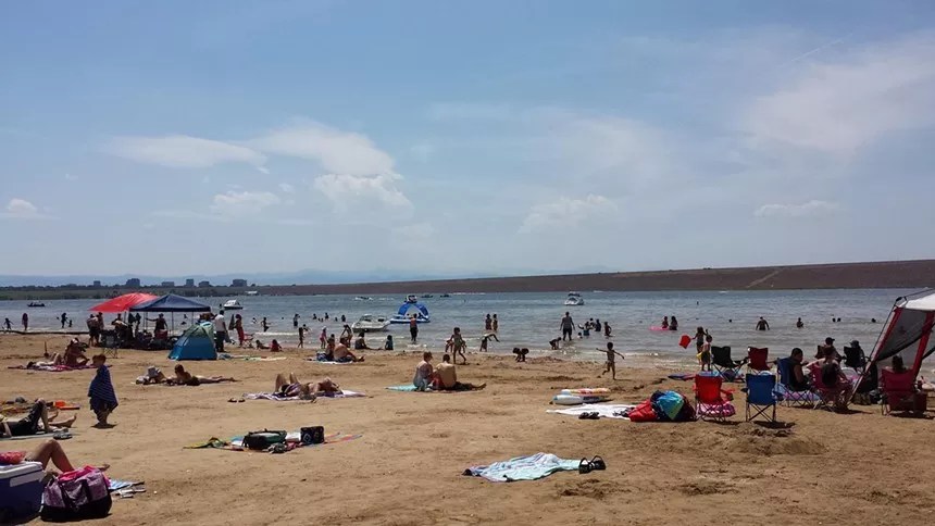 People on a sandy beach along Cherry Creek Reservoir