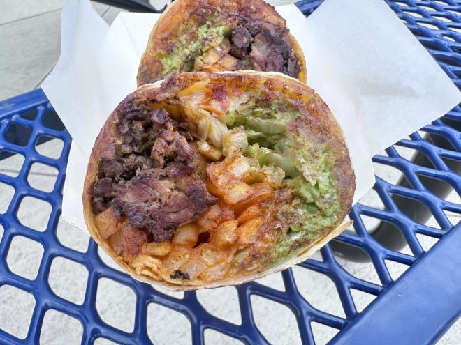 Burrito filled with carne asada, crispy fries, pico, de gallo, guacamole, sour cream, and salsa
