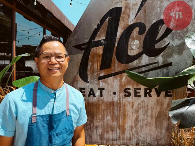 man in a blue shirt and blue apron