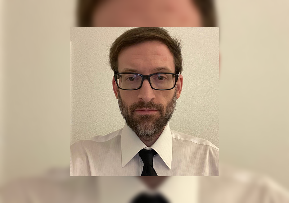 Professor in shirt, tie and glasses