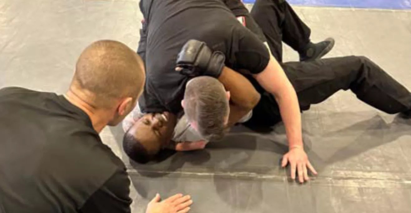 police officer on top of recruit in fight