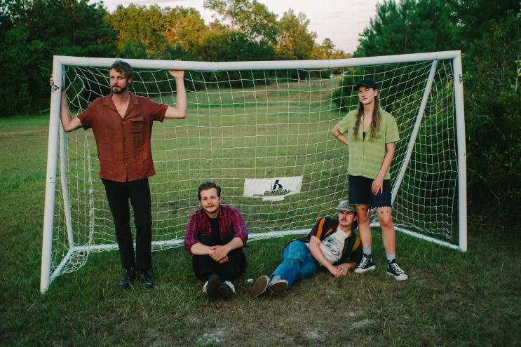 Four musicians in front of net.