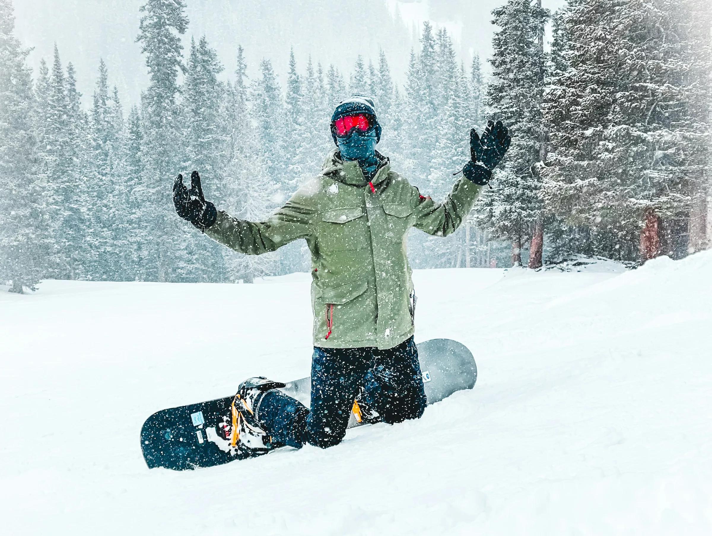 Man snowboards on Colorado mountain in snow