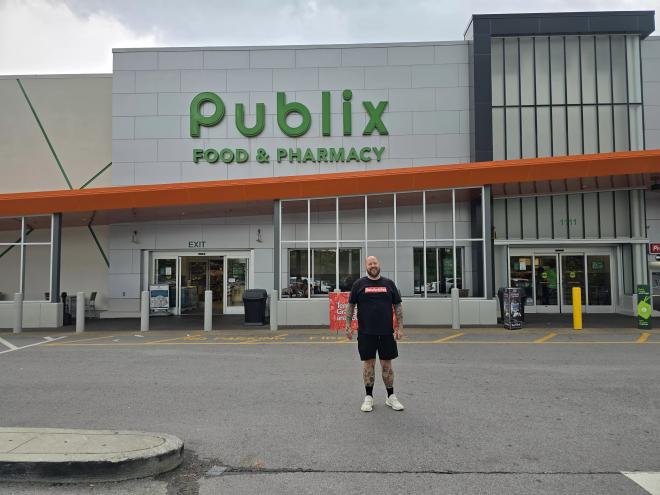 man standing in front of a publix super market