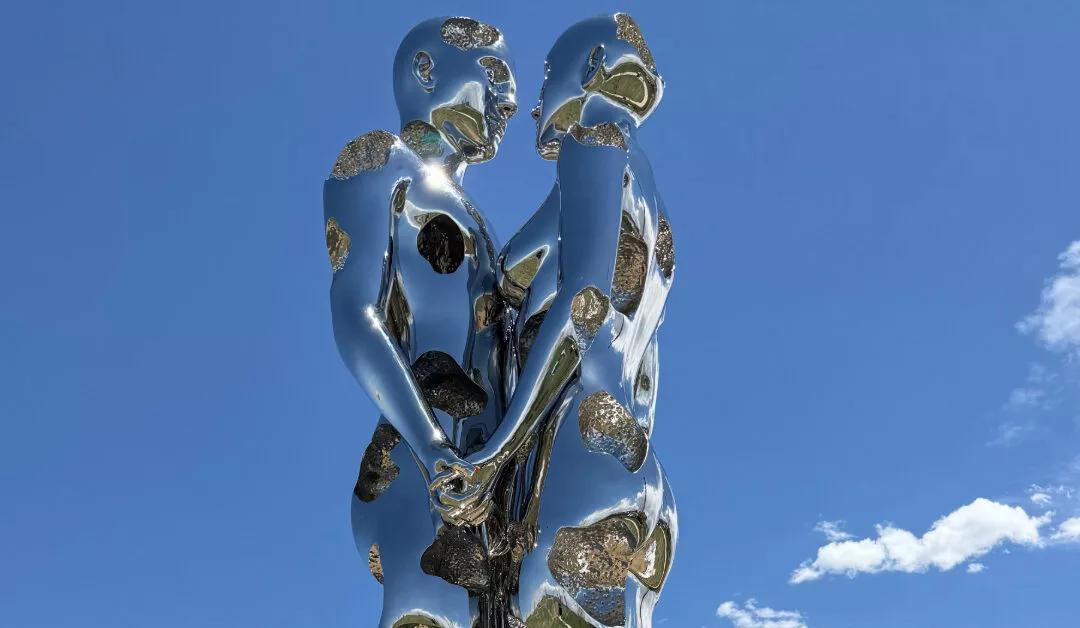 sculpture of metalic man and woman